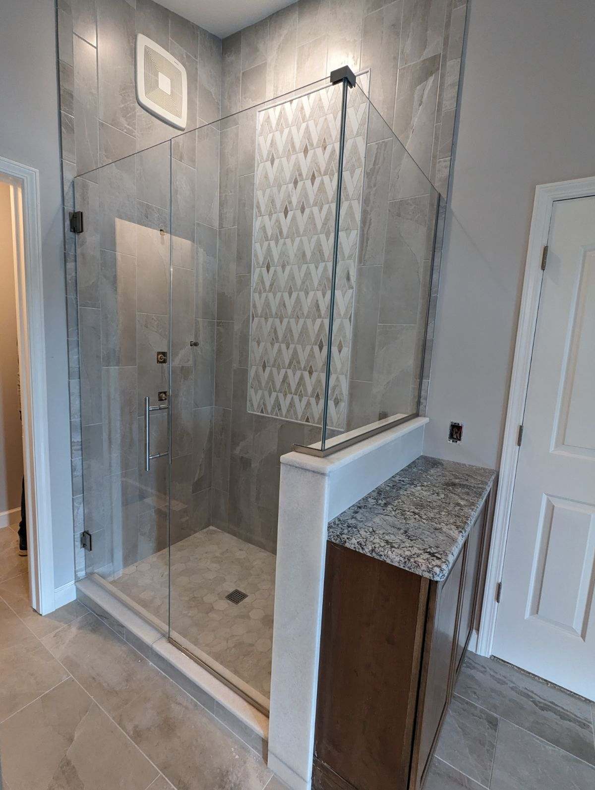 Frameless glass shower installation
